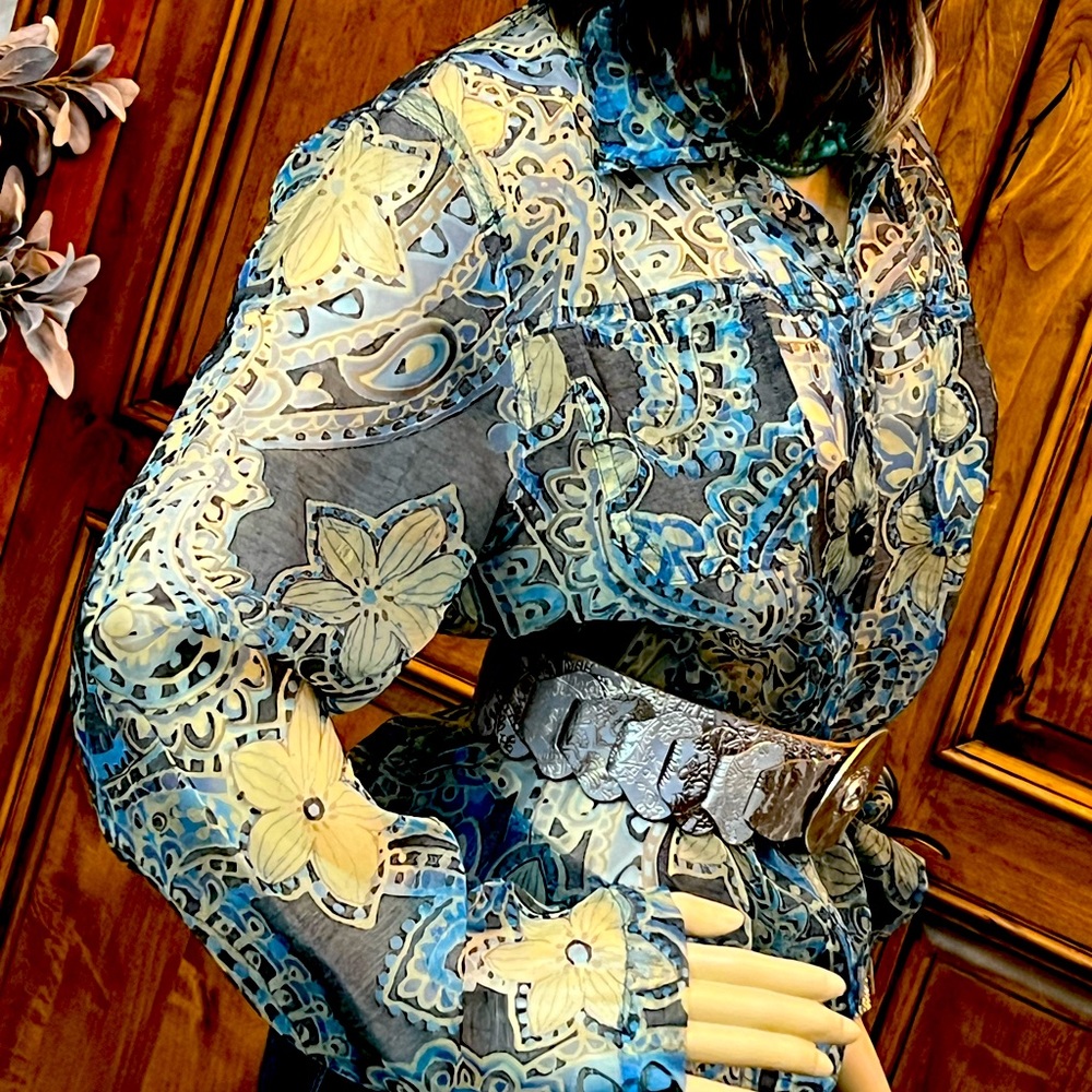 Light weight button up jacket in see through sheer material. Multi colored